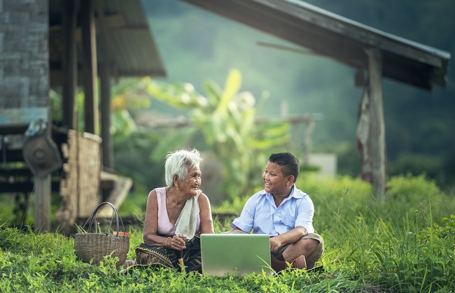 older woman and boy looking at laptop