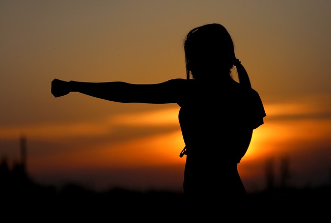 female silhouette with sunset behind