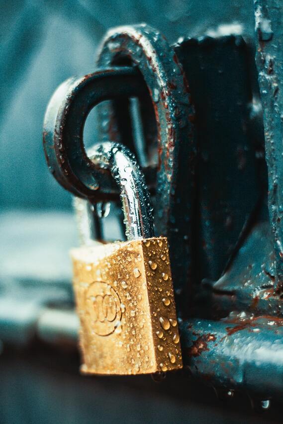 locked brass padlock covered in condensation