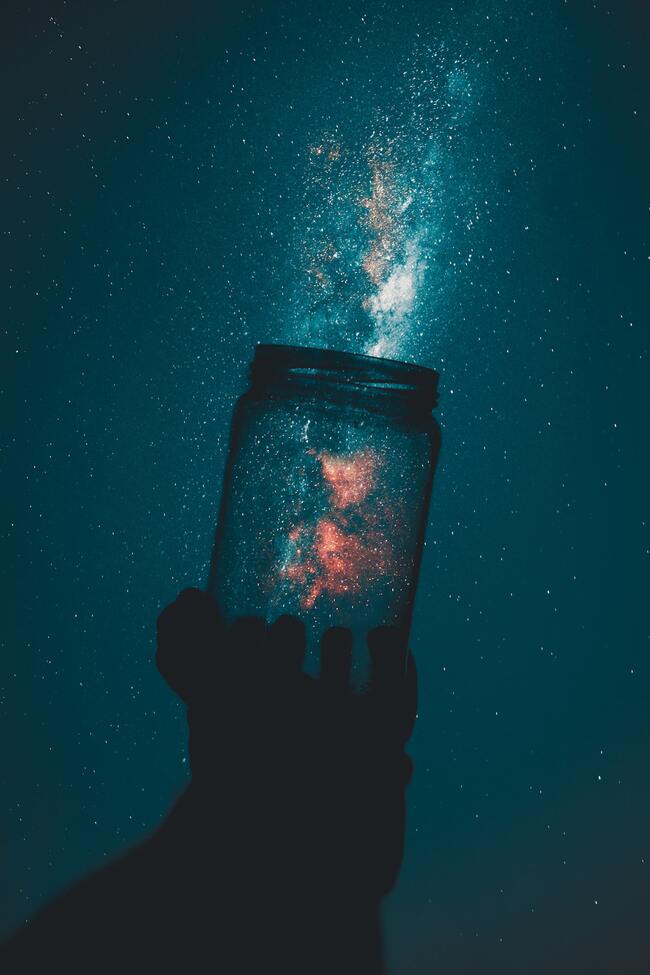 open jar letting out glittery dust at night