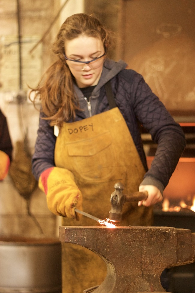 young woman doing metal work