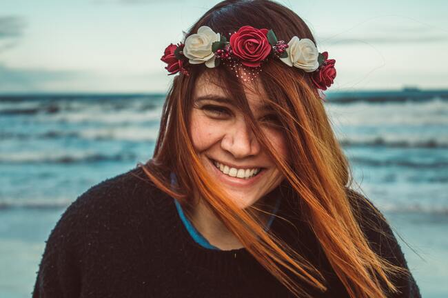 smiling woman wearing garland of flowers