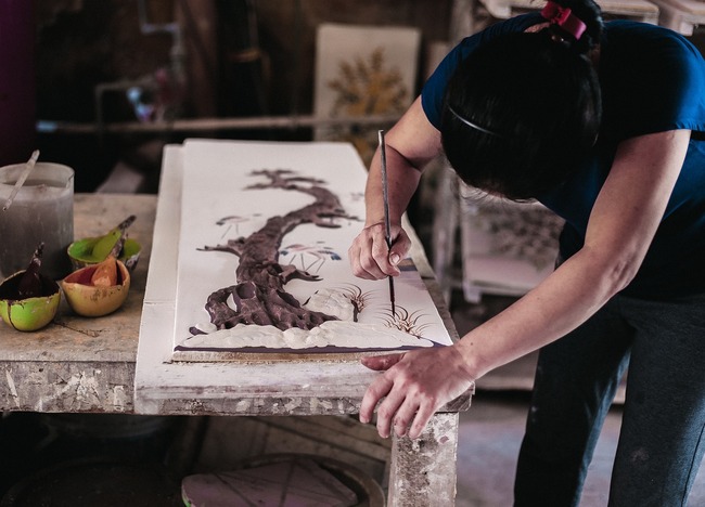 artist with paintbrush in hand