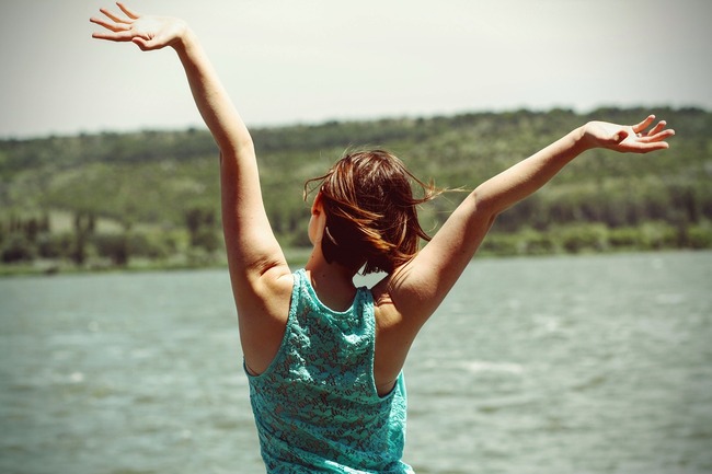 happy woman with arms in the air