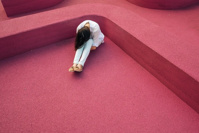 sad woman sitting on floor