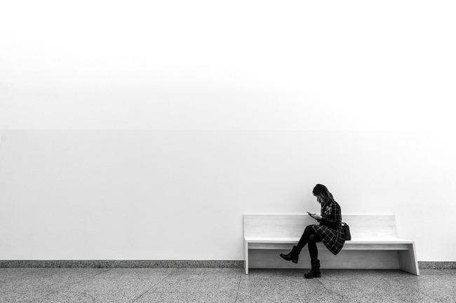 woman waiting on bench