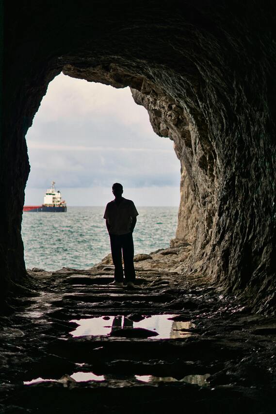 silhouette man looking at ocean