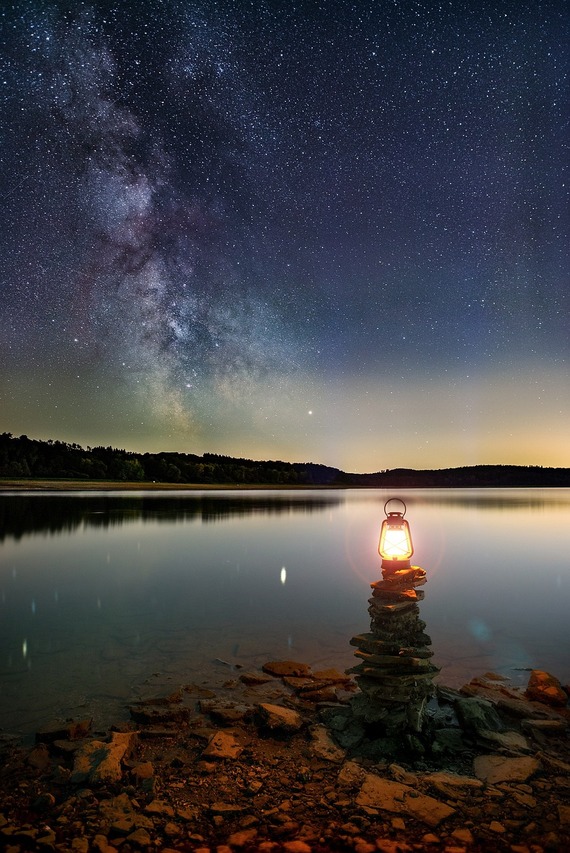 waterside lantern under stars